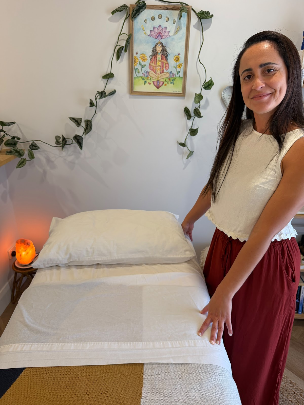 Simone smoothing fresh linen on the massage table
